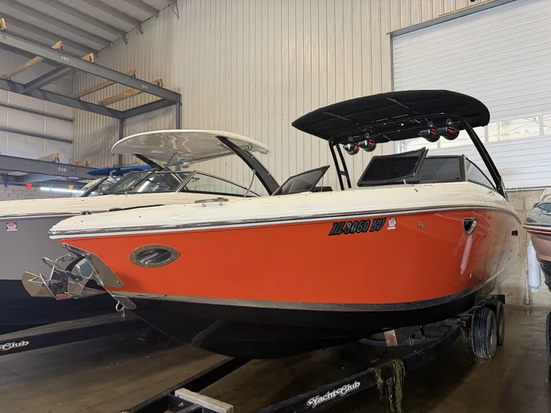 Slide: The Image of An orange 2022 Cobalt R30 boat is on a trailer in a storage facility. - 4