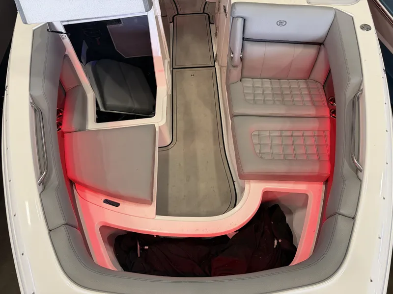 Slide: The Image of The image shows the cockpit of a 2022 Cobalt R30 boat with gray upholstery and red lighting. - 46