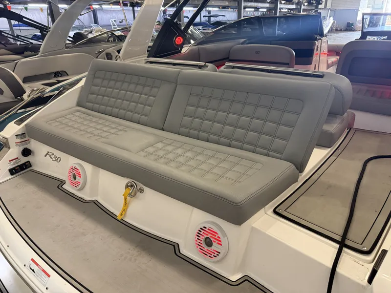 Slide: The Image of The image shows the stern of a 2022 Cobalt R30 boat with gray upholstered seating. - 14
