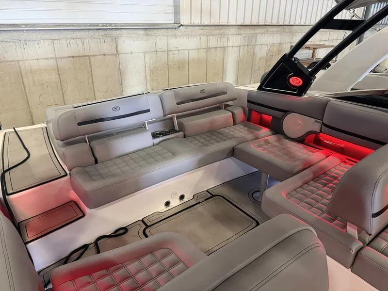 Slide: The Image of The image shows the interior of a 2022 Cobalt R30 boat with gray upholstery and red lighting. - 20