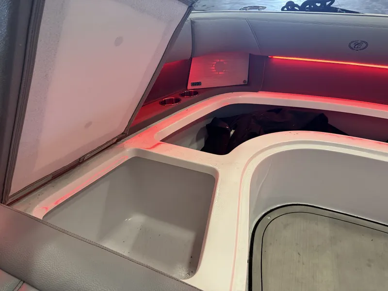 Slide: The Image of The image shows the interior of a 2022 Cobalt R30 boat with illuminated storage space. - 47