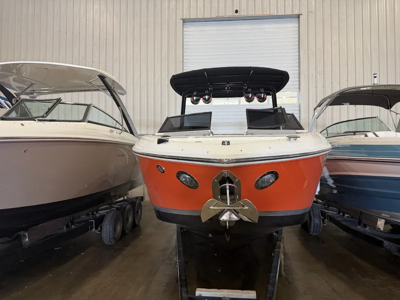 Slide: The Image of A red 2022 Cobalt R30 boat is in a warehouse, positioned between two other boats. - 3
