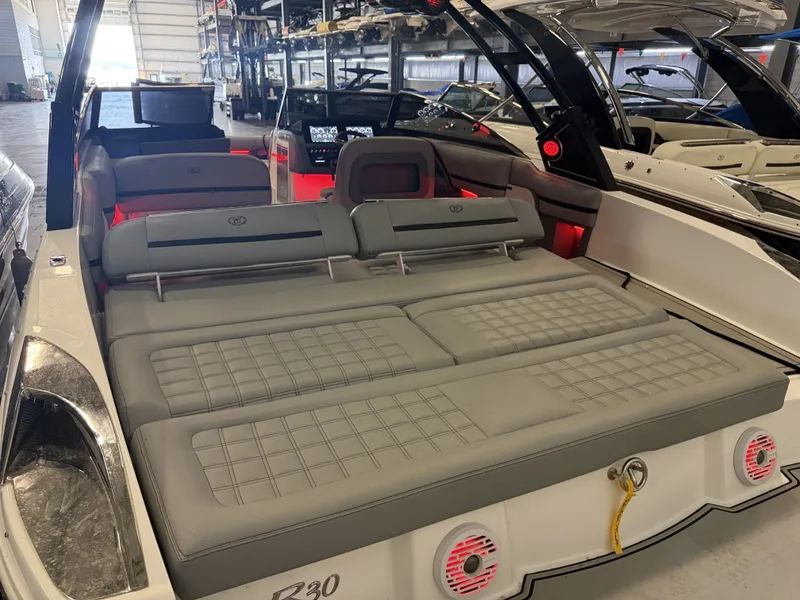 Slide: The Image of The image shows the cockpit of a 2022 Cobalt R30 boat with gray upholstery. - 15