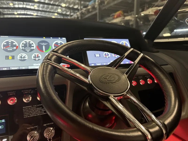Slide: The Image of The image shows the cockpit of a 2022 Cobalt R30 boat with a sleek steering wheel and digital displays. - 35