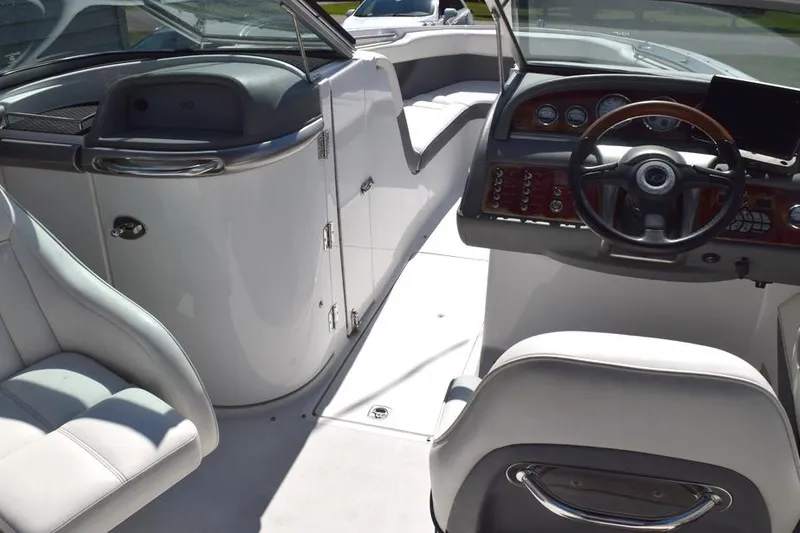 Slide: The Image of Interior of a 2006 Cobalt 240 boat, featuring sleek seating and a modern dashboard. - 16