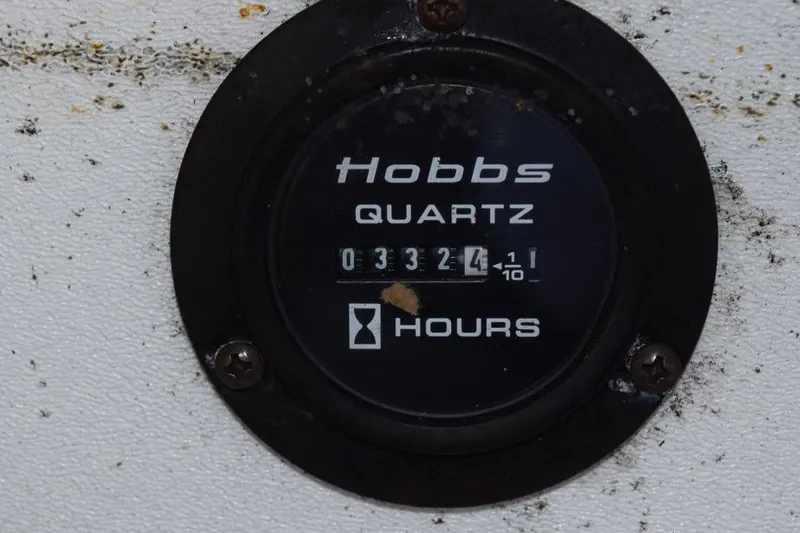 Slide: The Image of Hobbs quartz hour meter showing 3324.1 hours on a 2006 Cobalt 240. - 32