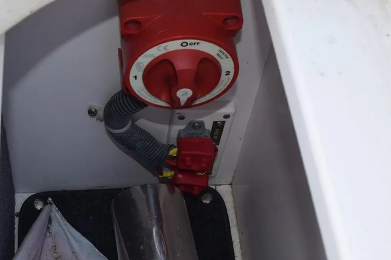 Slide: The Image of Red battery switch in a 2006 Cobalt 240 boat compartment. - 29
