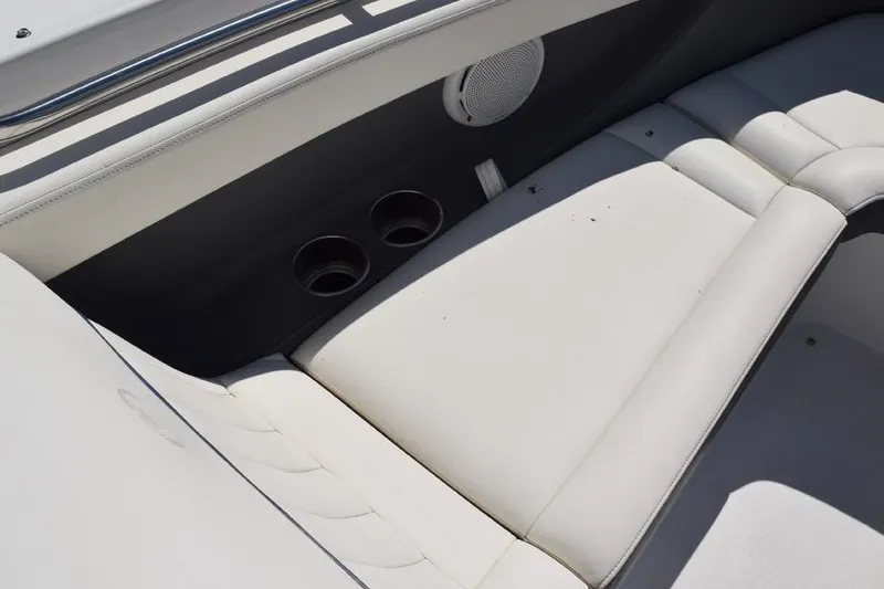Slide: The Image of Interior seating of a 2006 Cobalt 240 boat with cup holders and speaker. - 13
