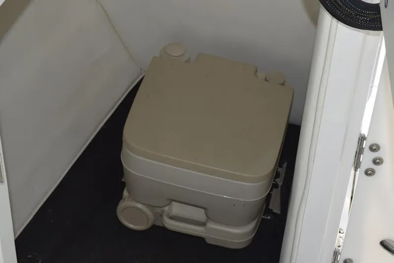 Slide: The Image of Portable toilet inside a 2006 Cobalt 240 boat cabin. - 28