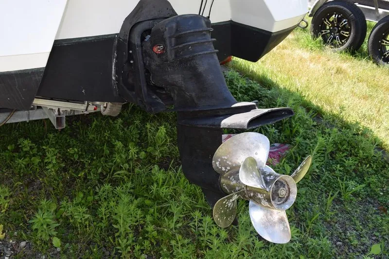 Slide: The Image of Close-up of a 2006 Cobalt 240 boat propeller and outdrive on grass. - 34