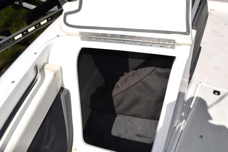 Slide: The Image of Open storage compartment on a 2006 Cobalt 240 boat, featuring white and gray interior. - 27