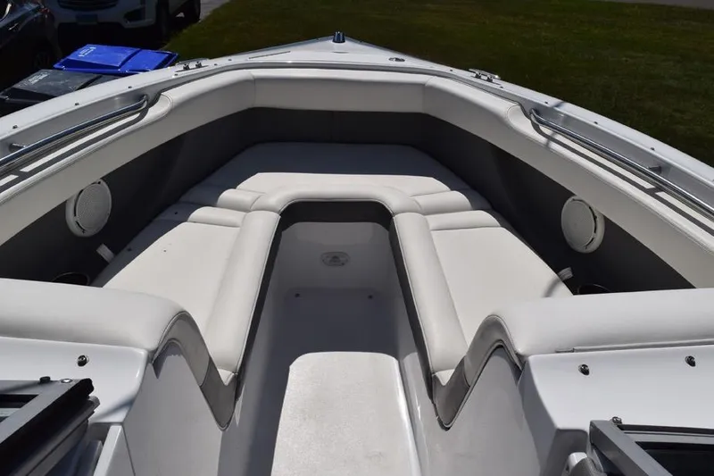 Slide: The Image of 2006 Cobalt 240 boat interior with white cushioned seating and stainless steel railings. - 12