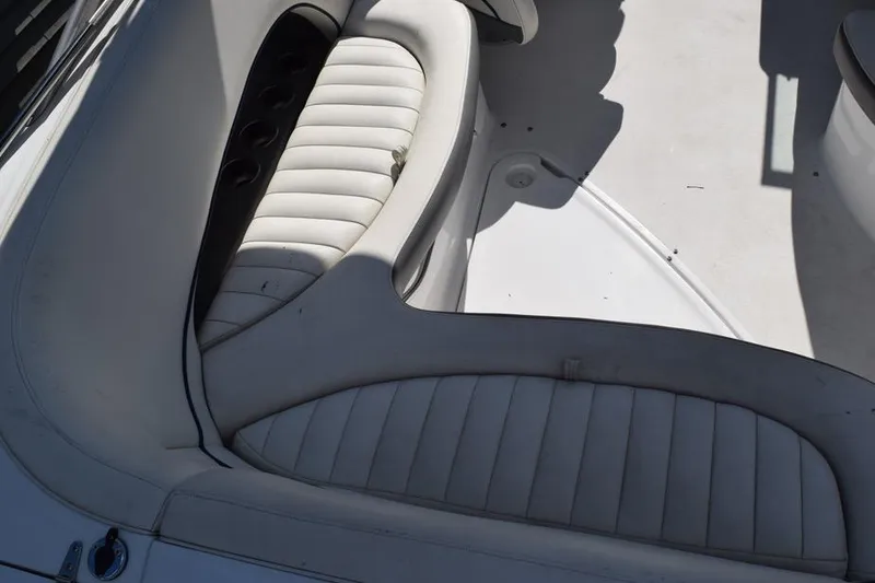 Slide: The Image of Interior seating of a 2006 Cobalt 240 boat, featuring white cushioned seats. - 17