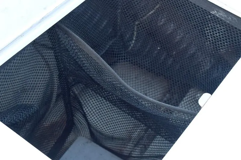 Slide: The Image of Mesh storage compartment in a 2006 Cobalt 240 boat. - 25