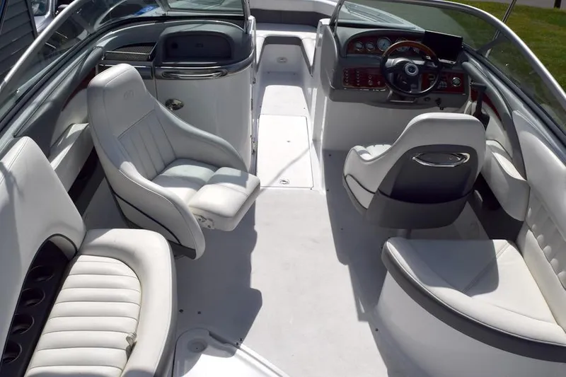 Slide: The Image of 2006 Cobalt 240 boat interior with white seating and sleek dashboard design. - 15