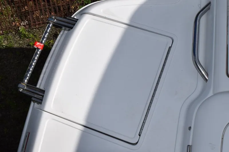 Slide: The Image of 2006 Cobalt 240 boat swim platform with ladder and handle in sunlight. - 24