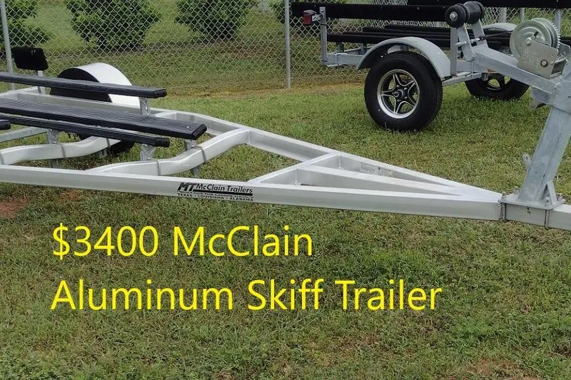Slide: The Image of $3400 McClain aluminum skiff trailer on grass, Delta Boatworks 1550, 2027 model. - 7