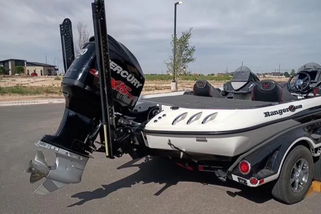 Slide: The Image of 2017 Ranger Z521 Comanche Cup-Equipped boat with Mercury engine, parked outdoors. - 3
