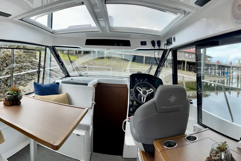 Slide: The Image of Interior of 2023 Jeanneau NC Weekender 895 boat with helm and seating area. - 9