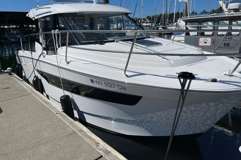 Slide: The Image of 2023 Jeanneau NC Weekender 895 docked at marina under clear blue sky. - 36