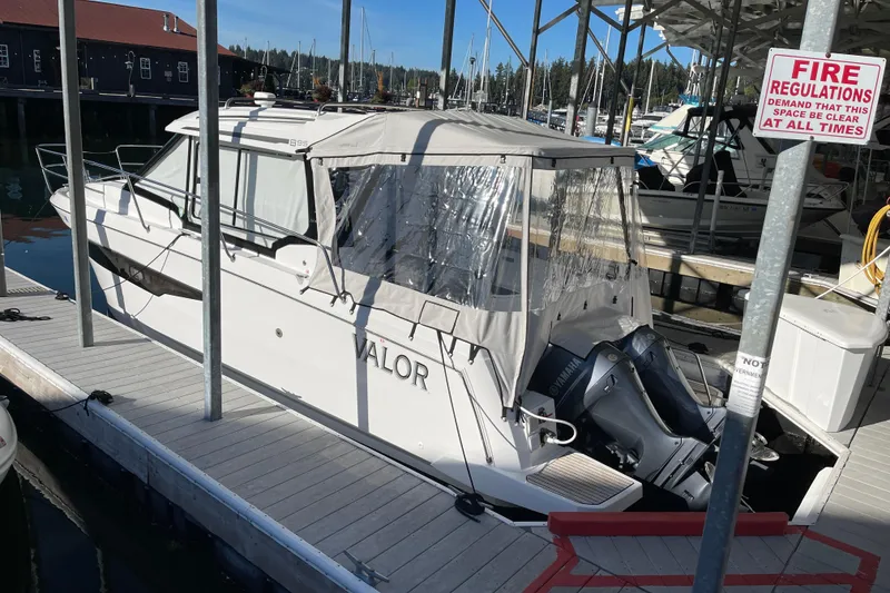 Slide: The Image of 2023 Jeanneau NC Weekender 895 docked at marina with Yamaha outboard engines. - 3