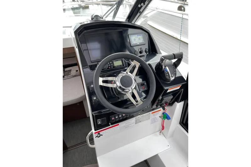 Slide: The Image of 2023 Jeanneau NC Weekender 895 helm with modern controls and navigation display. - 19