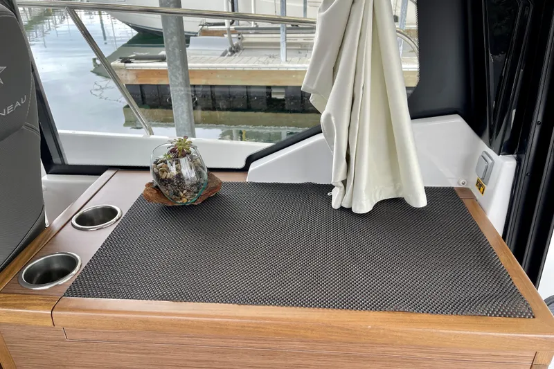 Slide: The Image of Interior of 2023 Jeanneau NC Weekender 895 with plant decor and cup holders. - 14