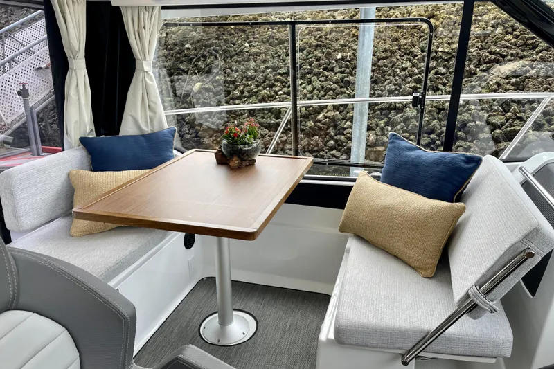 Slide: The Image of Interior of 2023 Jeanneau NC Weekender 895 with cozy seating and table. - 12