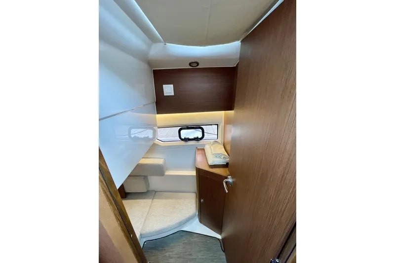 Slide: The Image of 2023 Jeanneau NC Weekender 895 cabin interior with modern wood finish and cozy seating. - 26