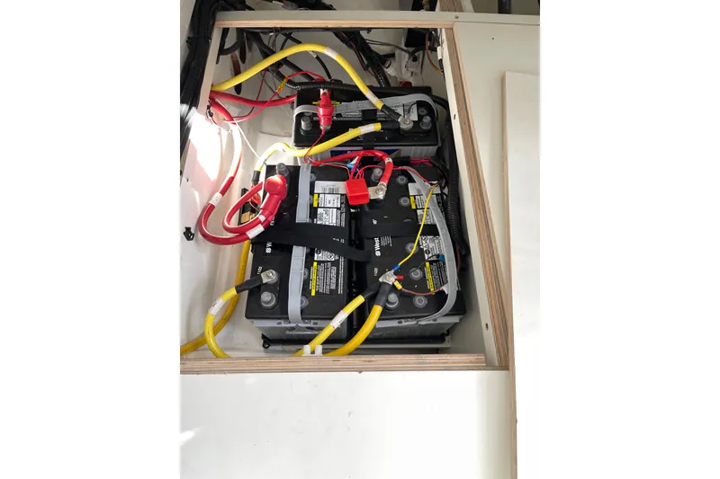 Slide: The Image of Battery compartment of 2023 Jeanneau NC Weekender 895 with connected cables. - 28