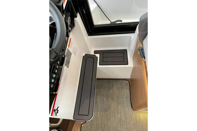 Slide: The Image of Interior view of 2023 Jeanneau NC Weekender 895 helm station with controls and seating. - 18