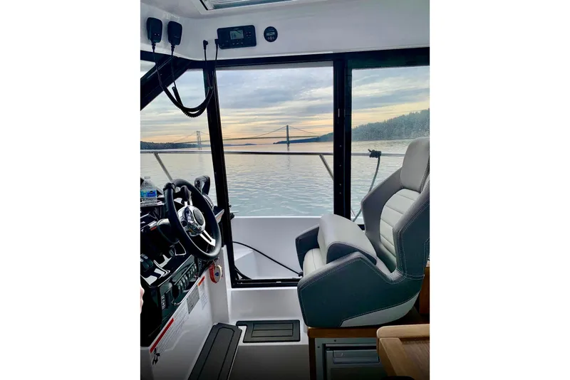 Slide: The Image of Interior view of 2023 Jeanneau NC Weekender 895 boat with scenic water backdrop. - 38