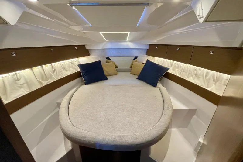 Slide: The Image of Luxurious interior cabin of 2023 Jeanneau NC Weekender 895 with cozy bedding and cushions. - 20