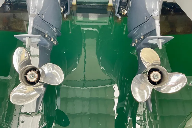 Slide: The Image of Twin propellers of 2023 Jeanneau NC Weekender 895 in green water. - 6