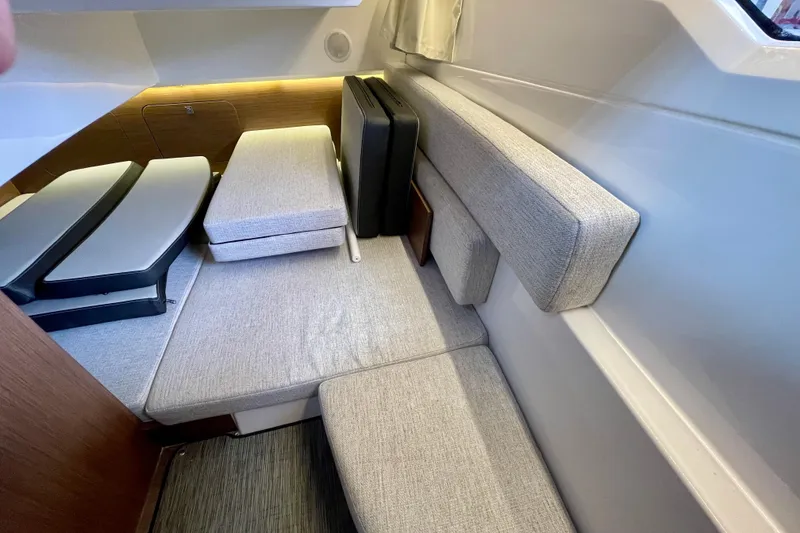 Slide: The Image of Interior cabin of 2023 Jeanneau NC Weekender 895 with cushioned seating and modern design. - 25
