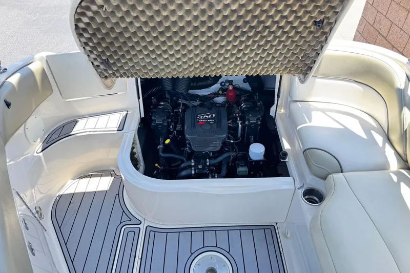 Slide: The Image of 2007 Sea Ray 240 Sundeck engine compartment with open hatch, showcasing interior details. - 27