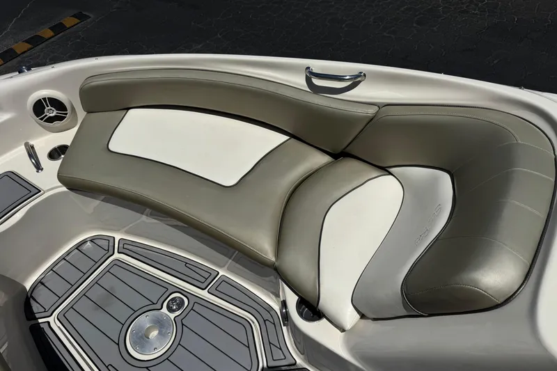 Slide: The Image of 2007 Sea Ray 240 Sundeck interior seating with gray and white upholstery. - 21