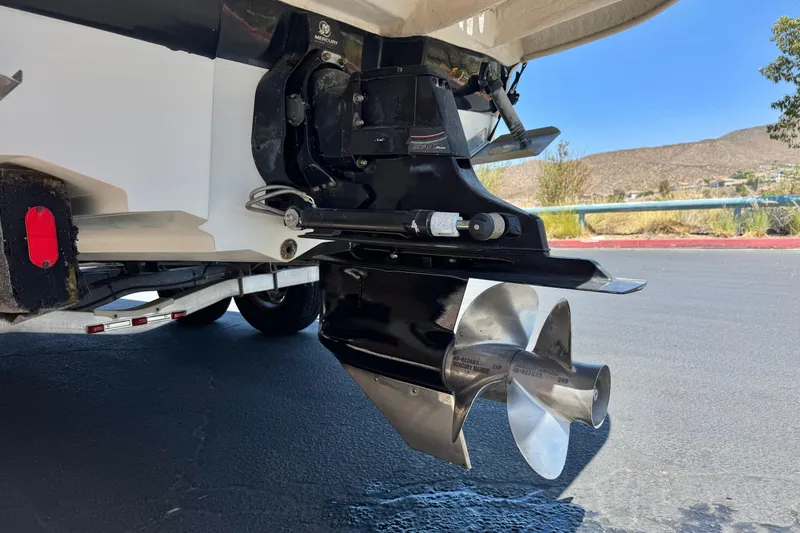 Slide: The Image of 2007 Sea Ray 240 Sundeck boat propeller and stern drive, parked on a trailer. - 9