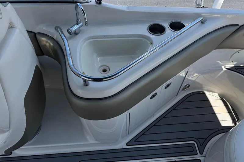 Slide: The Image of 2007 Sea Ray 240 Sundeck boat interior with sink and cup holders. - 29