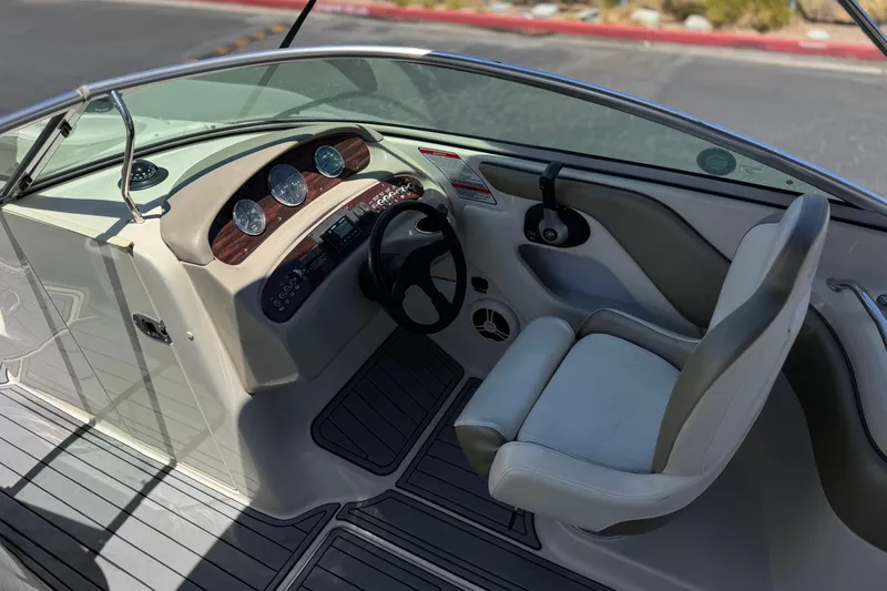 Slide: The Image of 2007 Sea Ray 240 Sundeck boat cockpit with steering wheel and gauges. - 39