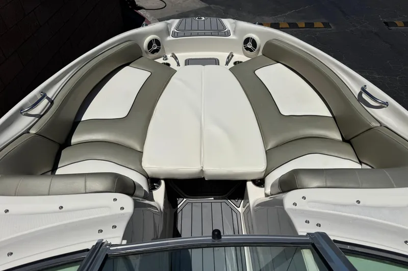 Slide: The Image of 2007 Sea Ray 240 Sundeck boat interior with cushioned seating and sleek design. - 19