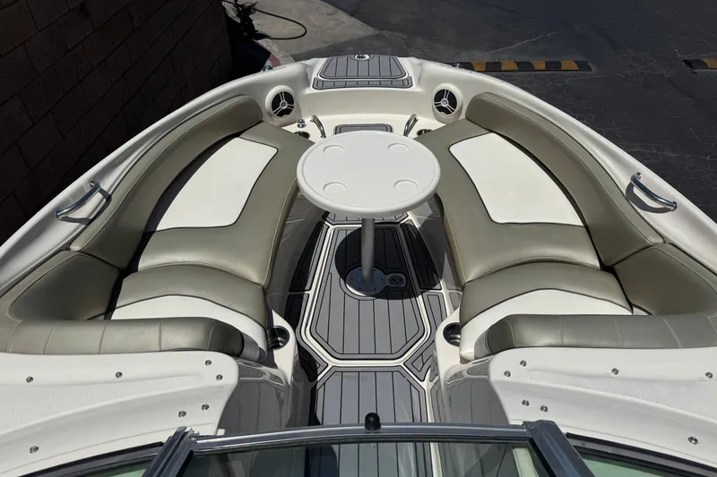 Slide: The Image of 2007 Sea Ray 240 Sundeck boat interior with seating and table. - 18