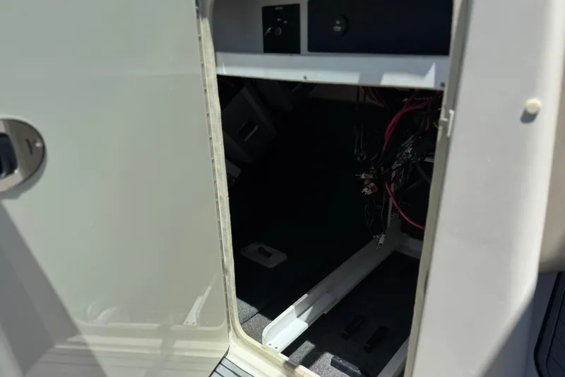 Slide: The Image of Open storage compartment on a 2007 Sea Ray 240 Sundeck boat, showing interior wiring. - 43