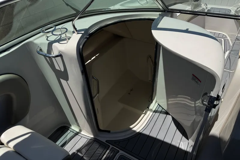 Slide: The Image of 2007 Sea Ray 240 Sundeck interior with open cabin door and seating area. - 37