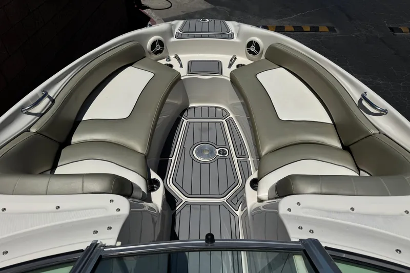 Slide: The Image of 2007 Sea Ray 240 Sundeck interior with cushioned seating and sleek design. - 17