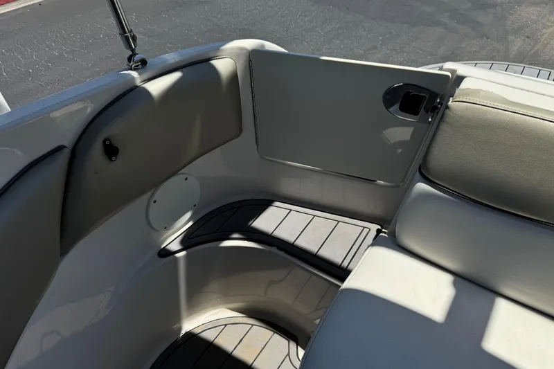 Slide: The Image of Interior seating area of a 2007 Sea Ray 240 Sundeck boat, featuring cushioned seats. - 31