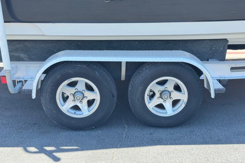Slide: The Image of Trailer wheels of a 2007 Sea Ray 240 Sundeck boat on pavement. - 44