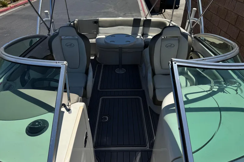 Slide: The Image of 2007 Sea Ray 240 Sundeck interior with seating and table, showcasing spacious design. - 24