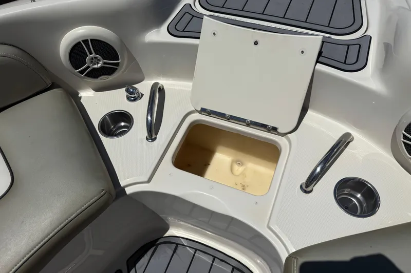 Slide: The Image of Interior of a 2007 Sea Ray 240 Sundeck boat with storage compartment and cup holders. - 22