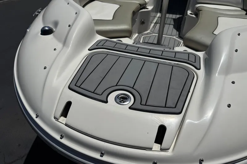 Slide: The Image of 2007 Sea Ray 240 Sundeck boat interior with cushioned seating and non-slip flooring. - 12